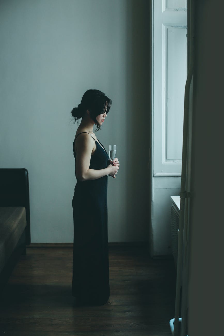 elegant asian woman with wine at home