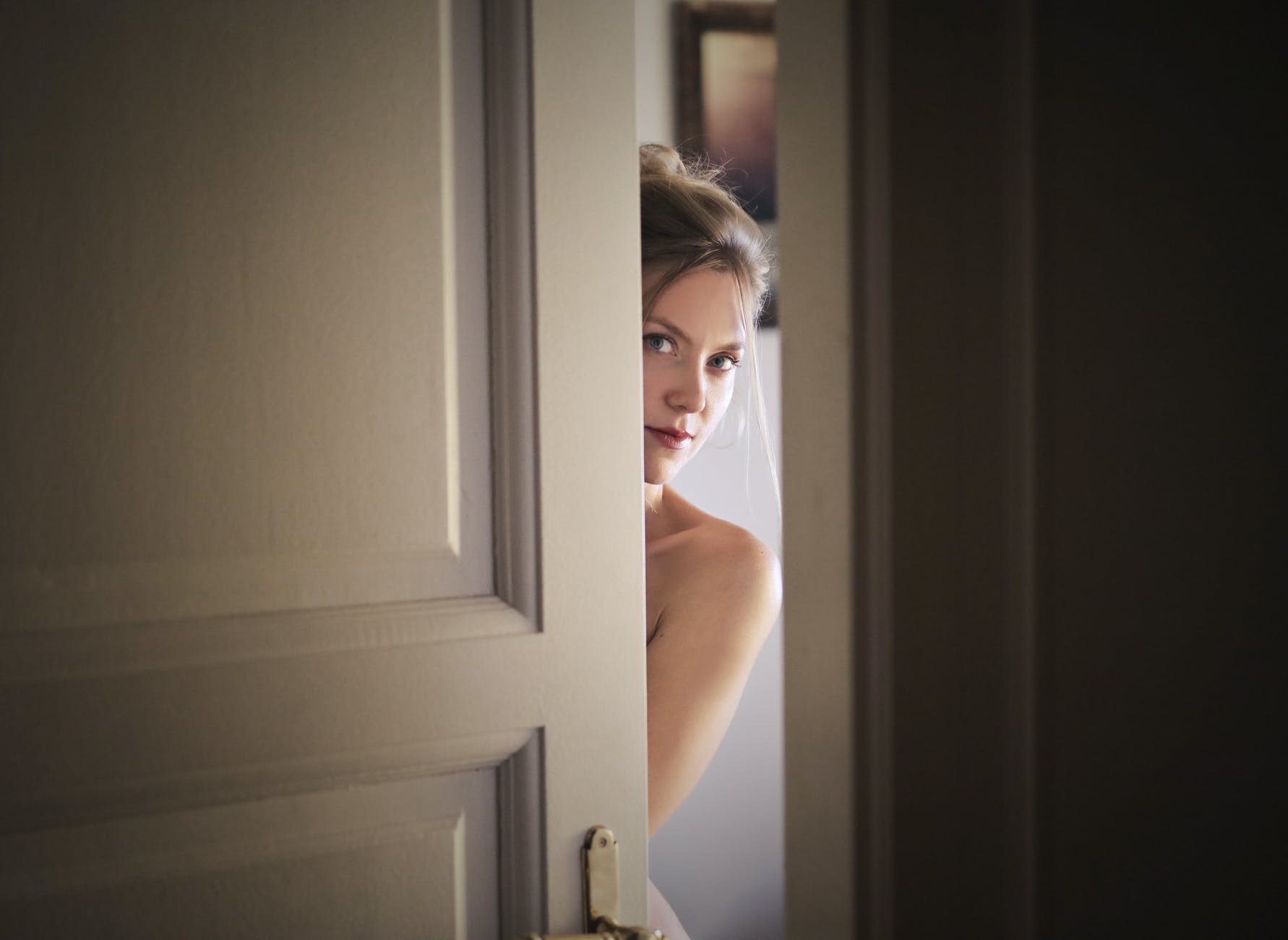 photo of woman behind door