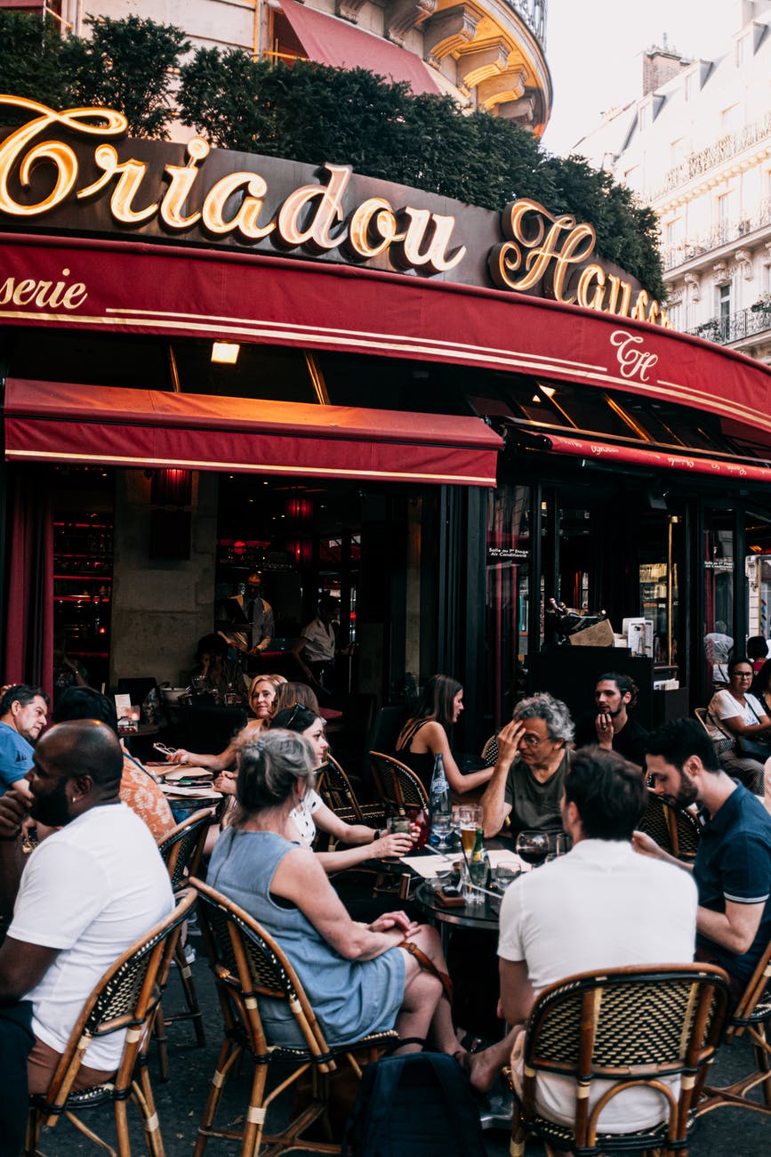 people sitting on chair outside restaurant