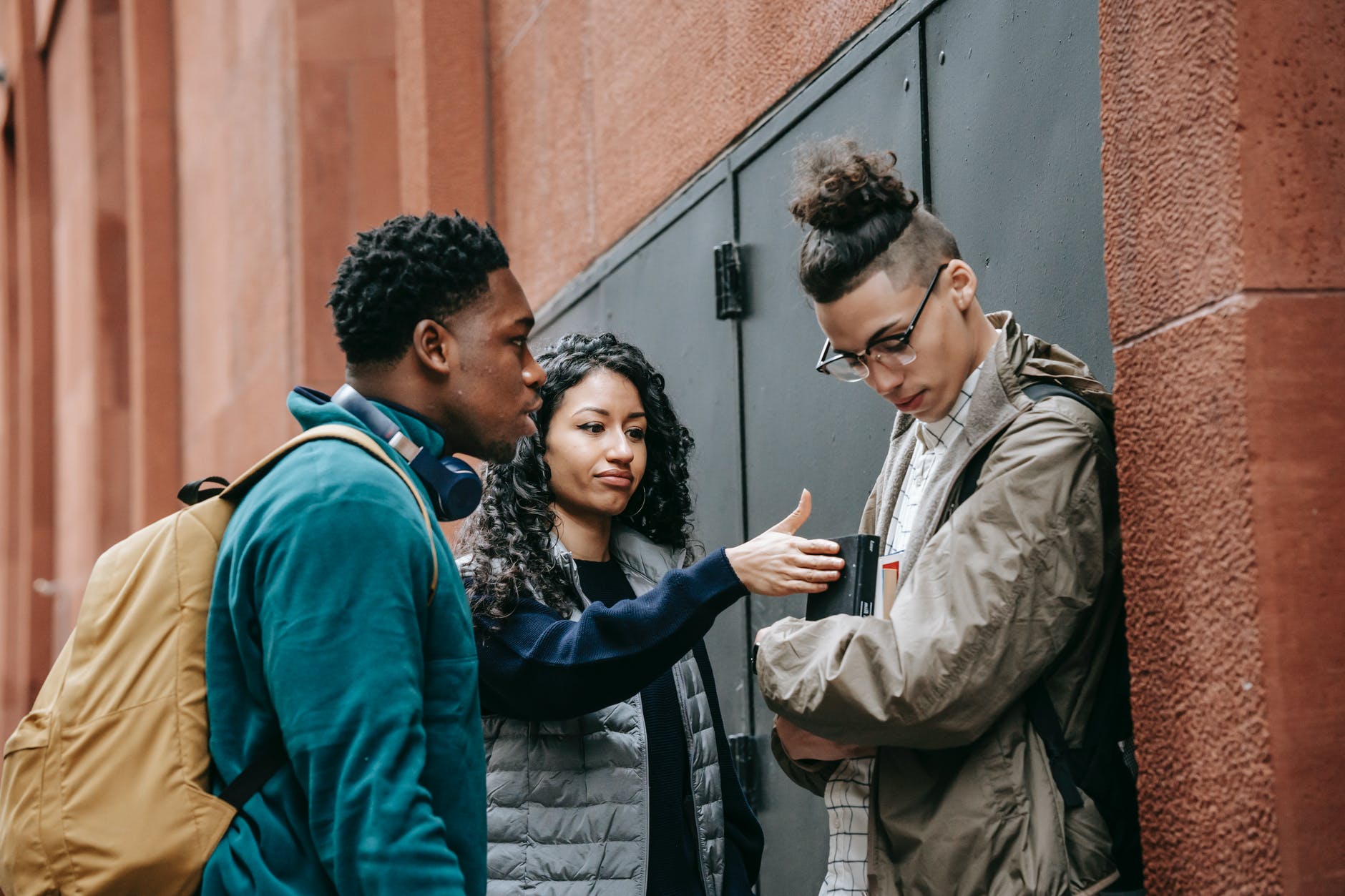 multiethnic students bullying guy on street